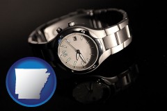 arkansas map icon and a wristwatch on a black background, with reflection