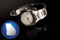 georgia map icon and a wristwatch on a black background, with reflection