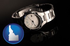 idaho map icon and a wristwatch on a black background, with reflection