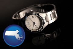 massachusetts map icon and a wristwatch on a black background, with reflection