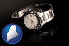 maine map icon and a wristwatch on a black background, with reflection