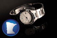 minnesota map icon and a wristwatch on a black background, with reflection