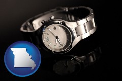 missouri map icon and a wristwatch on a black background, with reflection