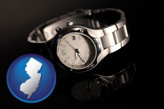 new-jersey map icon and a wristwatch on a black background, with reflection