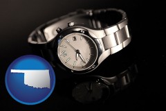 oklahoma map icon and a wristwatch on a black background, with reflection