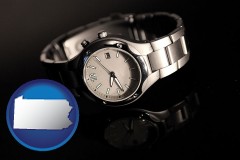 pennsylvania map icon and a wristwatch on a black background, with reflection